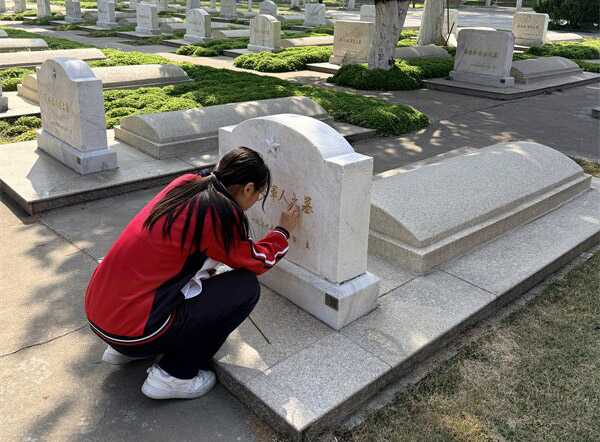 学生代表擦拭墓碑.jpg