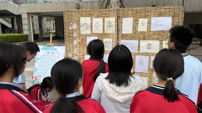 师生驻足欣赏学生作品.jpg